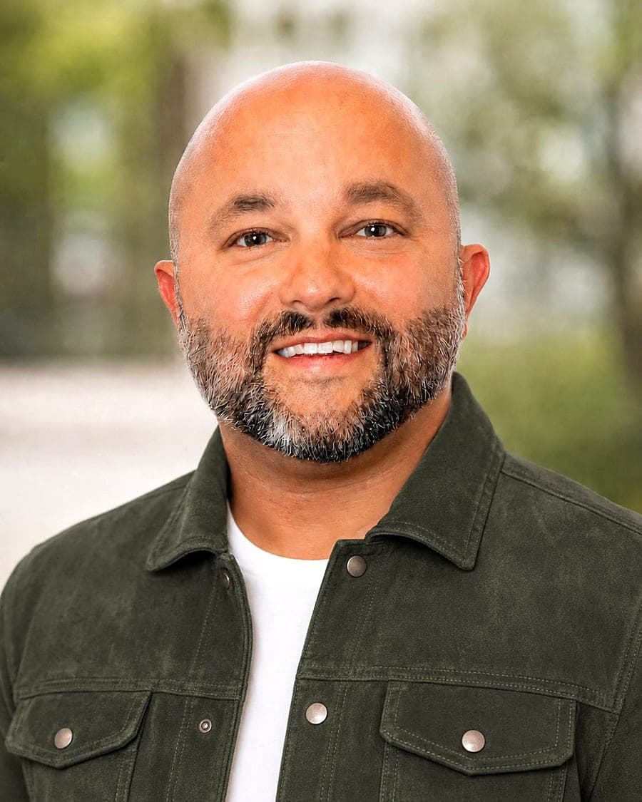 Derek Evans, M.A., LPC-MHSP(A), smiling in a dark green jacket